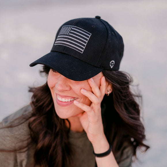 Outsider Black Hat with Black and White American Flag patch modeled on a woman