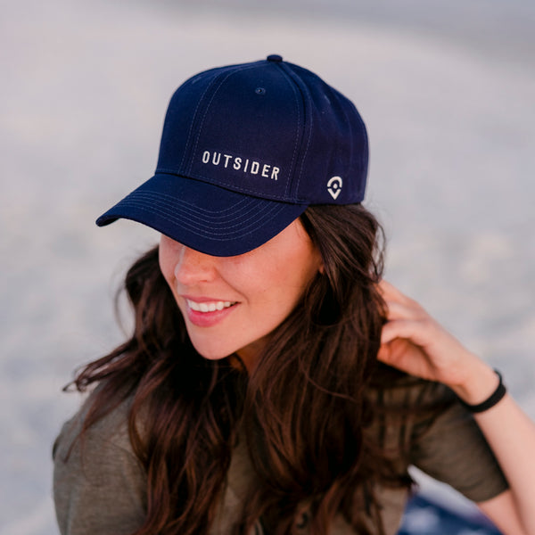 Navy Blue Cotton Twill hat with white embroidered Outsider logo offset on the front modeled on a woman