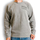 Outsider Tilt Crew Neck Unisex Sweatshirt in Light Grey with Black Logo modeled on a man